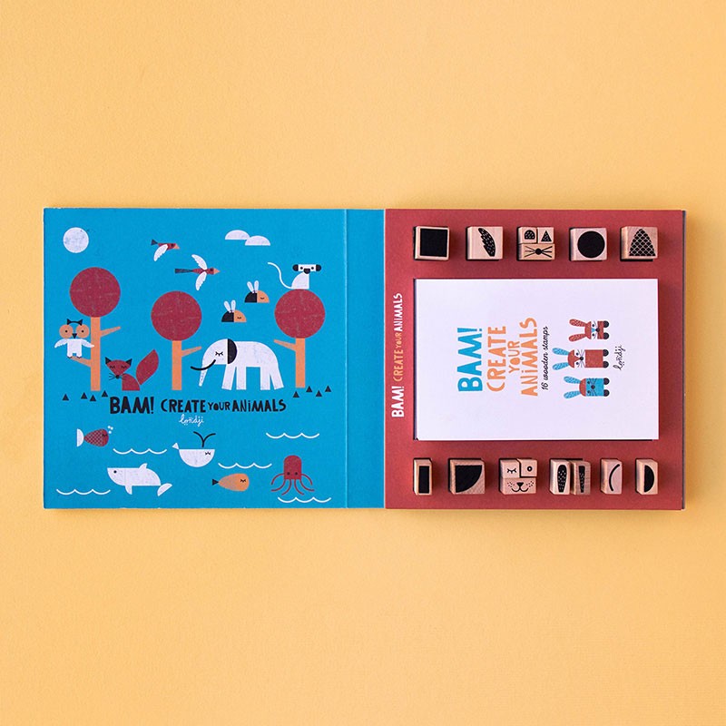 Open Londji BAM! Create Your Animals set showing wooden stamps and illustrated guide inside.