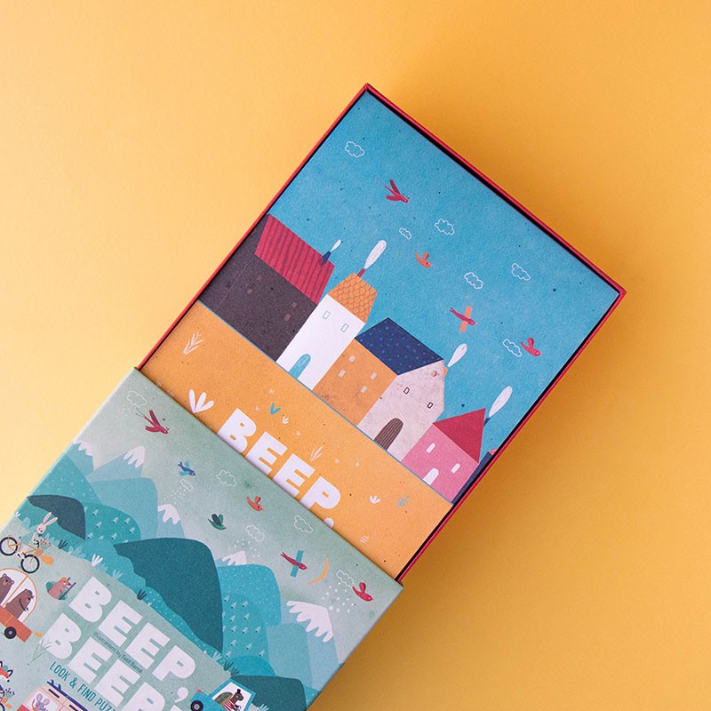 Open Londji Beep Beep Puzzle box showing colorful illustrated houses and sky design.