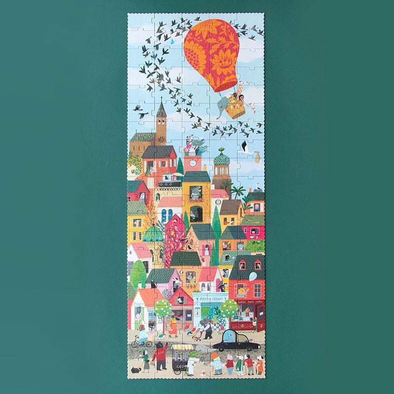 Finished Londji Look Up puzzle featuring a colorful town scene with people, houses, and a hot air balloon.