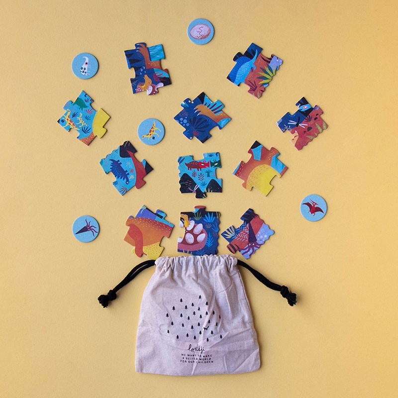 Londji My Little Dino Look & Find Pocket Puzzle pieces and round tokens spilling out of a drawstring fabric bag on a yellow background.