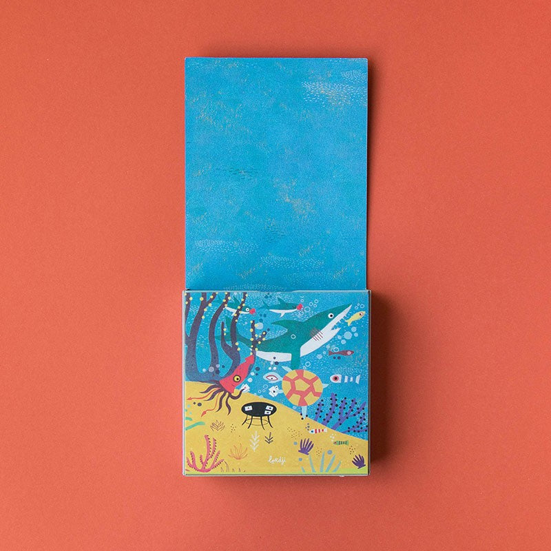 Partially opened My Little Ocean Pocket Puzzle box revealing a bright undersea illustration with fish, coral, and a turtle.