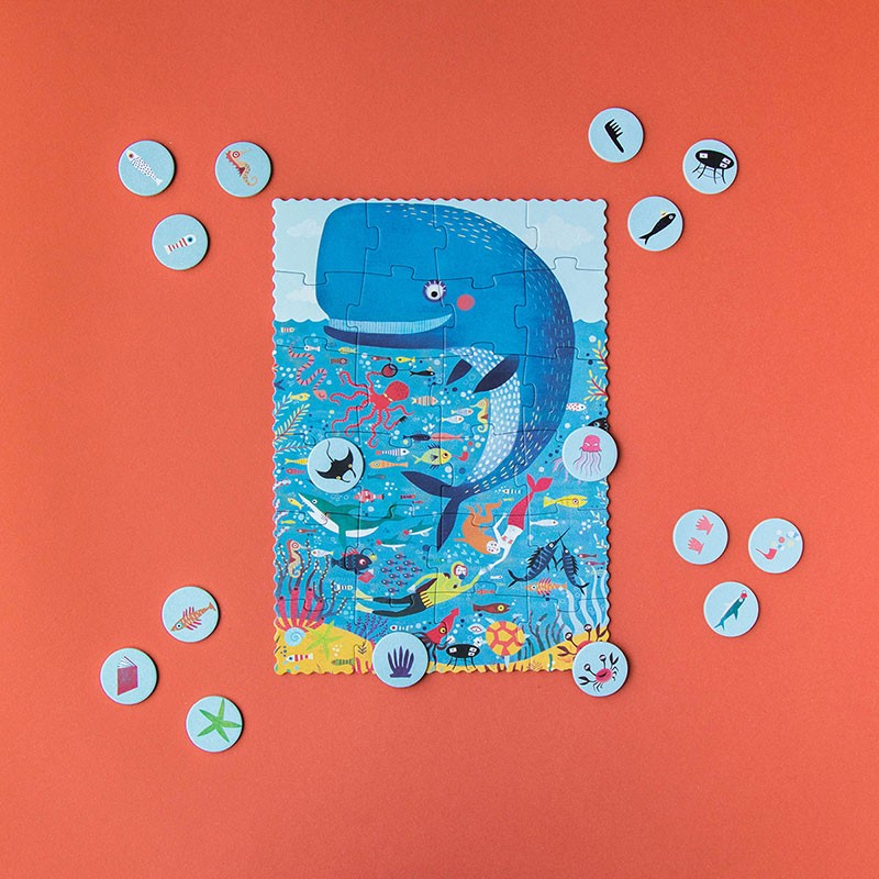 Completed Londji My Little Ocean Puzzle showing a cheerful whale surrounded by fish, coral, and ocean icons used for the matching look-and-find game.