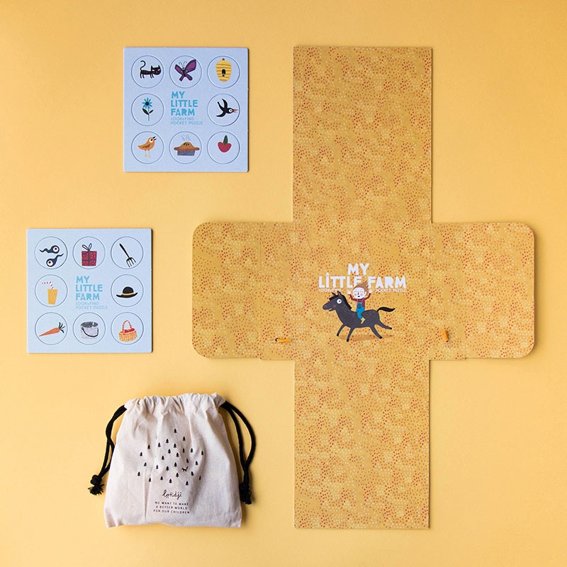 Contents of Londji’s My Little Farm Puzzle — illustrated cards, yellow fold-out board, and a cotton storage bag with black drawstrings.