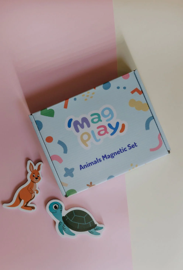 Flat lay of the MagPlay Animal Magnetic Set box on a pink and cream background, with kangaroo and turtle magnets displayed beside it.
