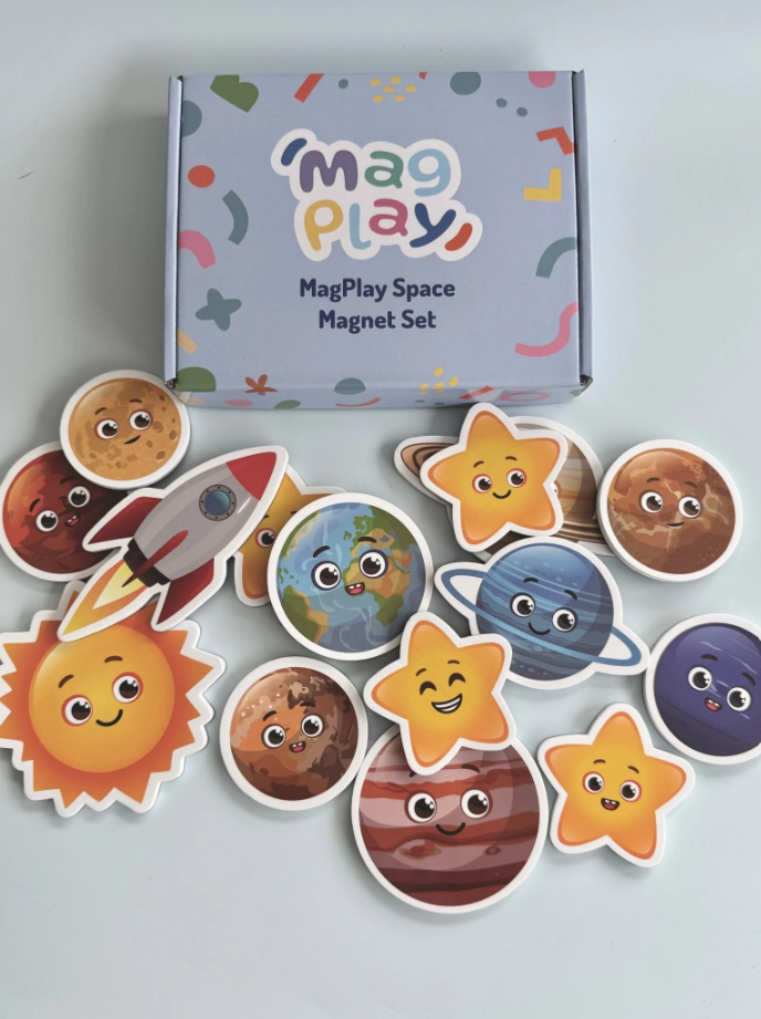 Flat lay of the MagPlay Space Magnet Kit box with colourful planet, sun, rocket, and star magnets displayed on a white surface.