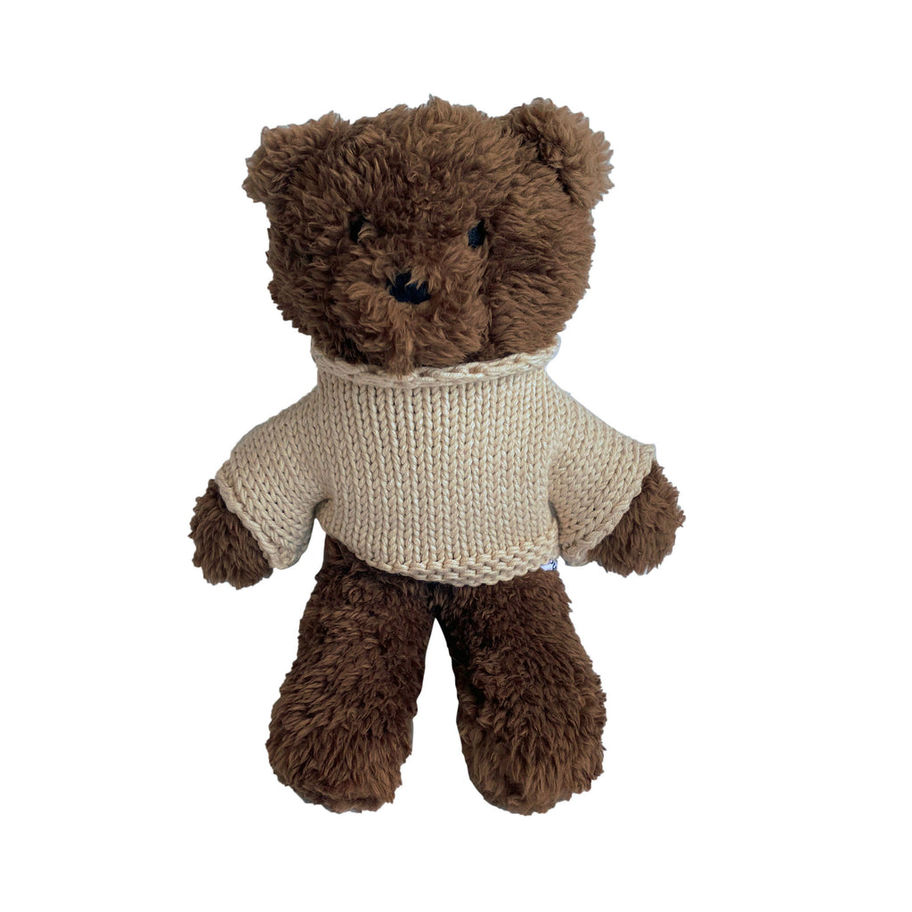 Medium Milo Bear plush toy made from soft chocolate brown plush fabric, wearing a cozy cream knitted Australian merino wool jumper, standing upright against a white background.