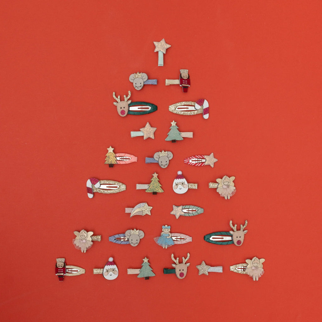 Christmas tree display made from Mimi & Lula holiday-themed hair clips including Santa, Rudolph, and stars.