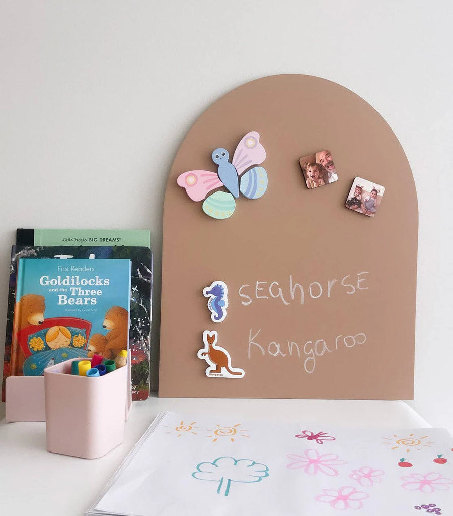 Clay Mini MagPlay decal featuring magnetic butterflies and animals, with words written in white chalk, styled next to books and a child’s drawing pad.