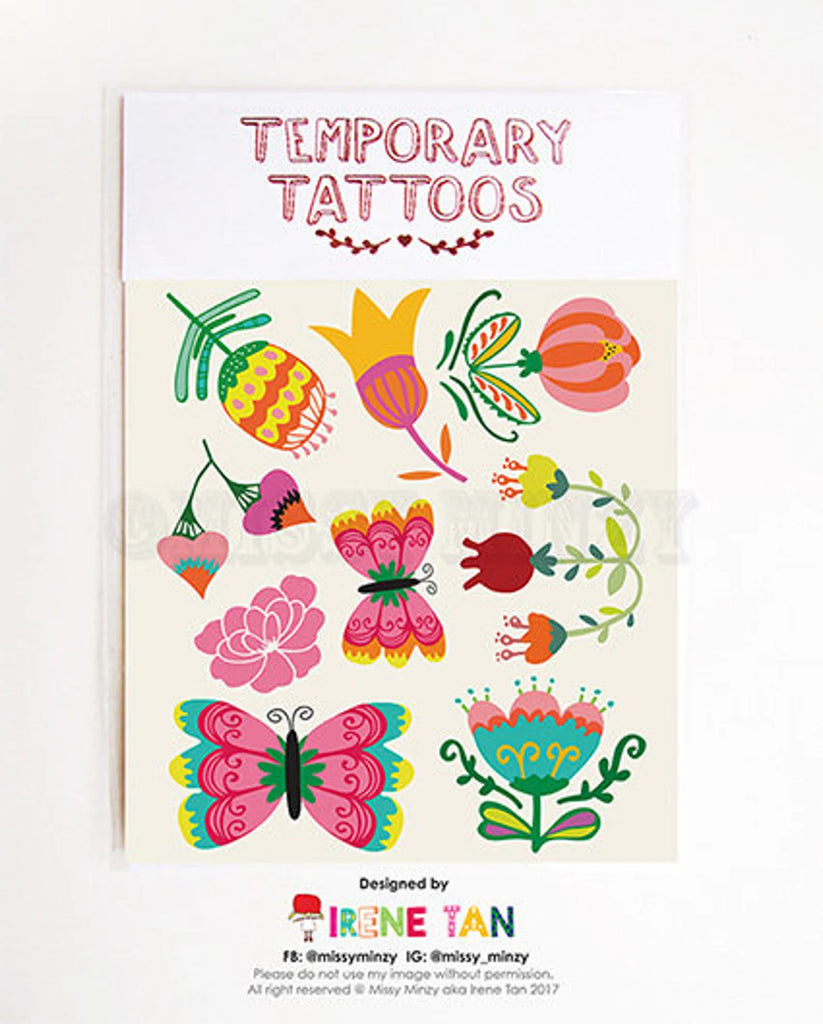 Flat lay of Missy Minzy temporary tattoos featuring colourful hand-drawn flowers and butterflies in a whimsical garden theme.
