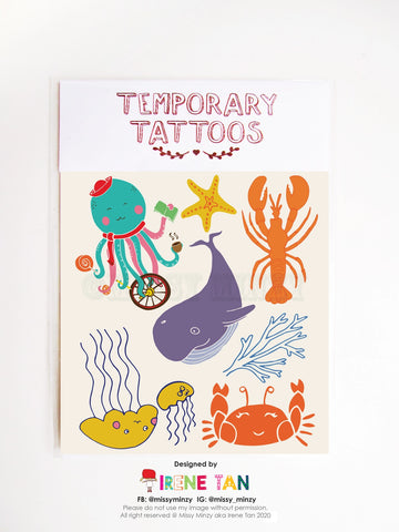 Sheet of colourful temporary tattoos featuring hand-drawn sea creatures, including a teal octopus holding coffee and cash, a purple whale, orange lobster, red crab, yellow jellyfish, coral, starfish, and more, designed by Missy Minzy.