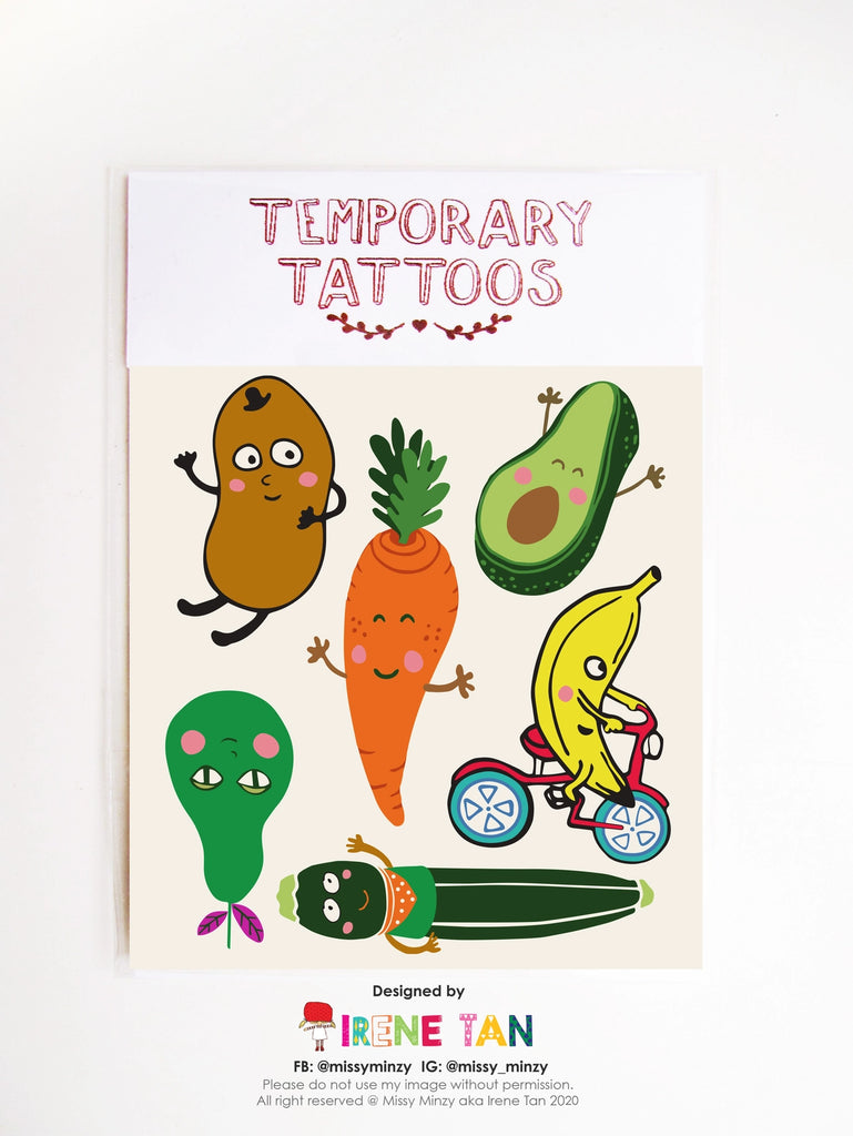 Sheet of playful temporary tattoos featuring hand-drawn fruit and vegetable characters, including a smiling carrot, avocado, potato, banana on a bike, cucumber, and more—designed by Missy Minzy.