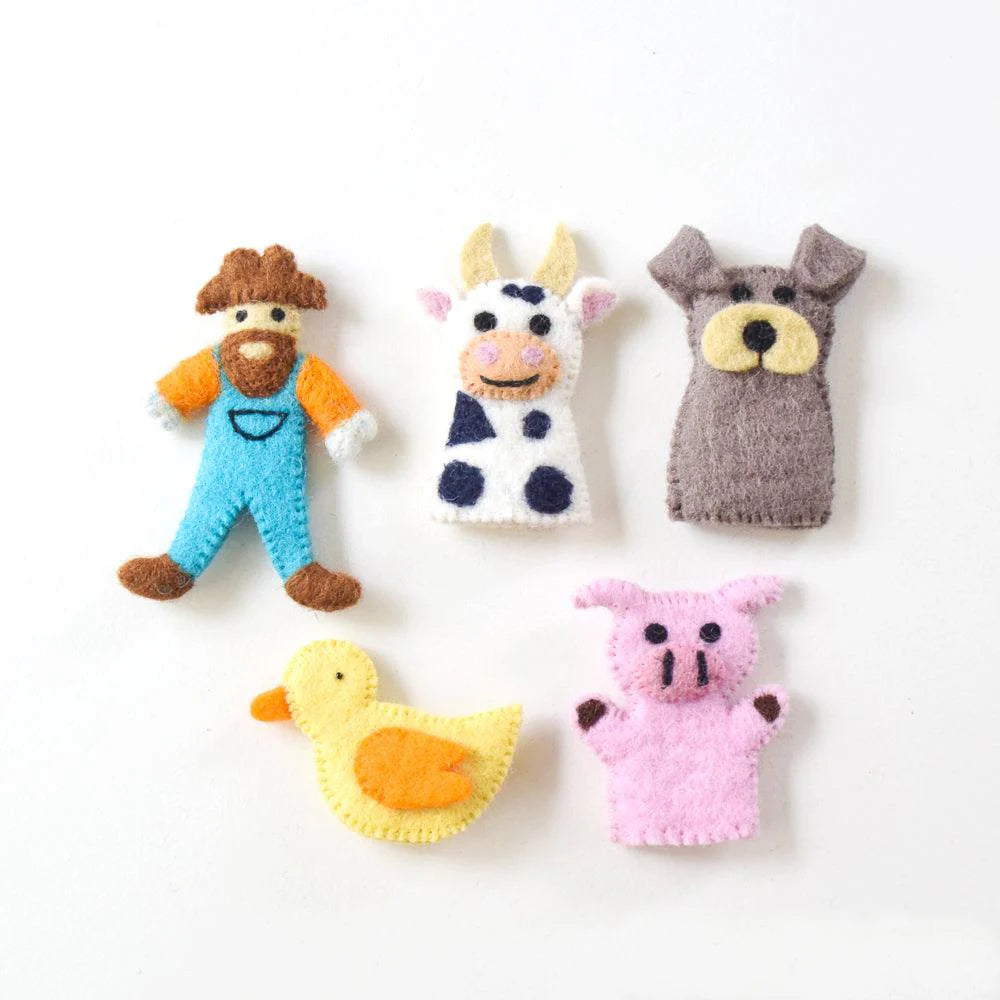 Close-up of felt finger puppets—farmer, cow, pig, dog, and duck—displayed on a neutral surface for detailed view.