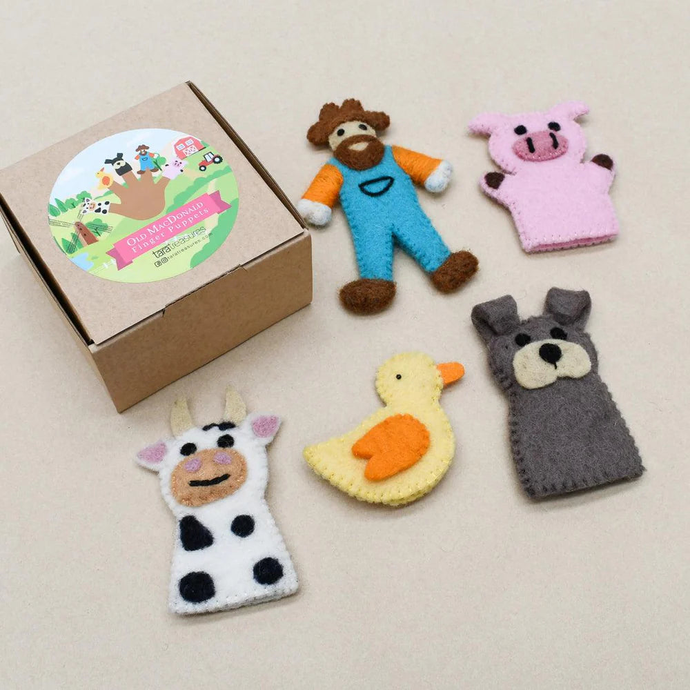 Old MacDonald and farm animal finger puppets arranged flat with illustrated cardboard box featuring farm-themed design.