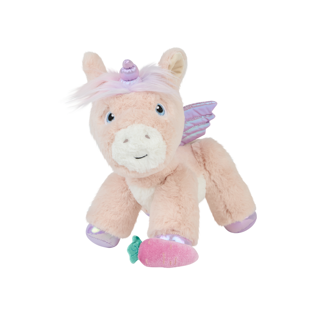 Front view of Shimmer the Dinkum Unicorn plush toy – Pink plush unicorn with lavender wings, iridescent hooves, rainbow mane, and pink magnetic carrot sitting besides front hoove.