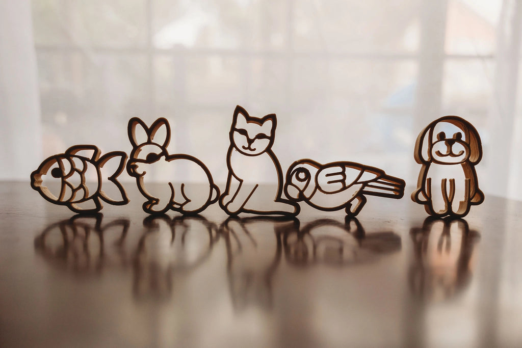 Row of Kinfolk Pantry pet-themed eco cutters standing upright, styled with soft natural light, showcasing rabbit, cat, dog, fish, and bird shapes.