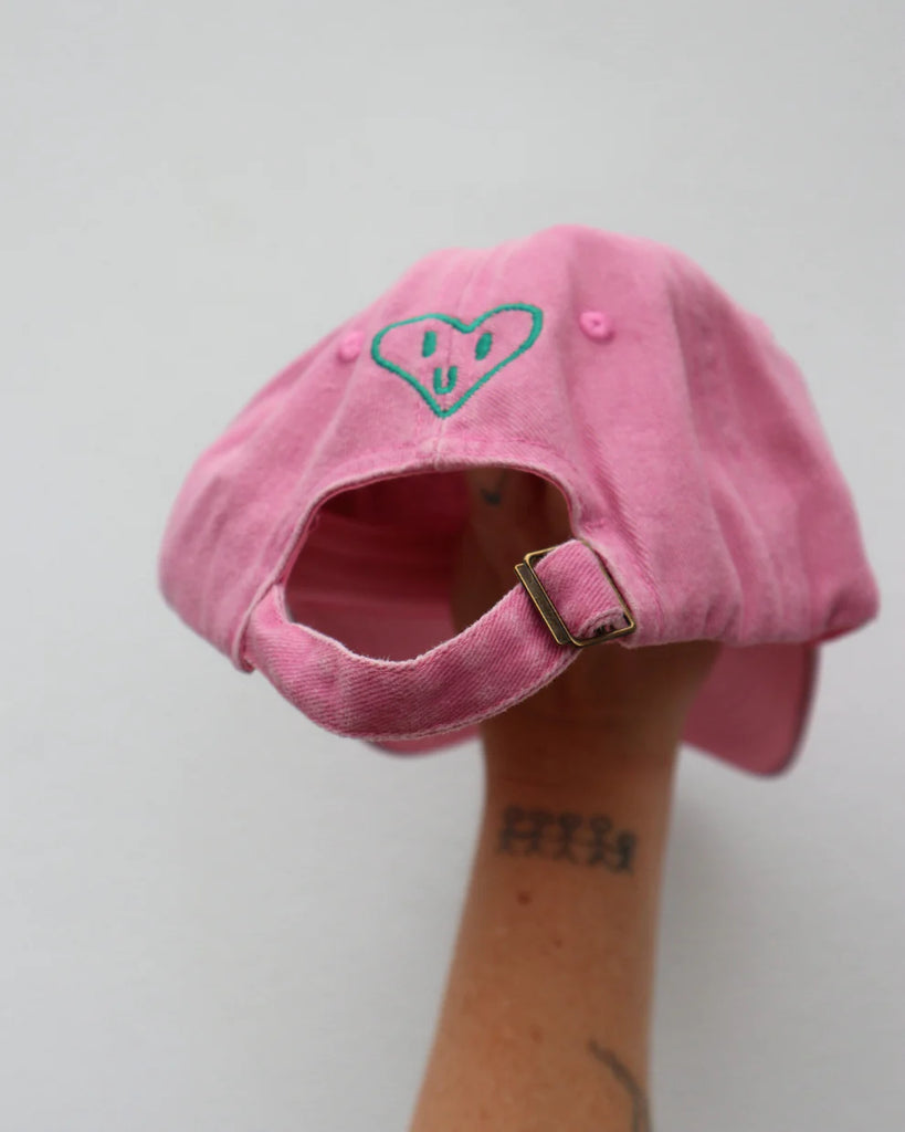 Back view of the pink kids "Handful" cap showing heart embroidery and adjustable strap, designed to fit ages 1 to 7 comfortably.