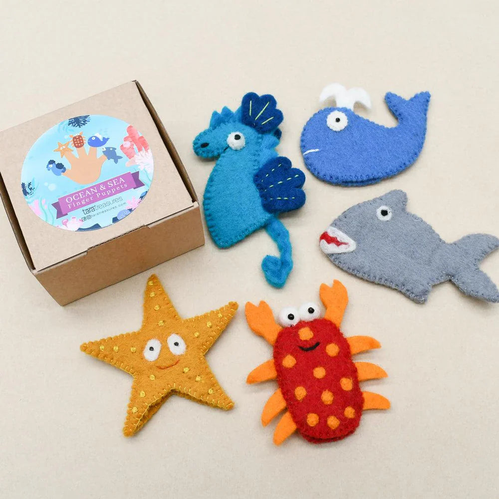 Ocean-themed felt finger puppets arranged beside a Tara Treasures gift box, featuring all five sea creatures in the set.