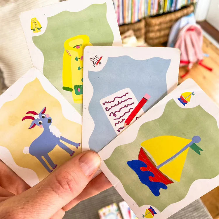 Several Sound Slam cards set up for gameplay, surrounded by children’s hands, capturing an active, engaging phonological awareness activity in progress.