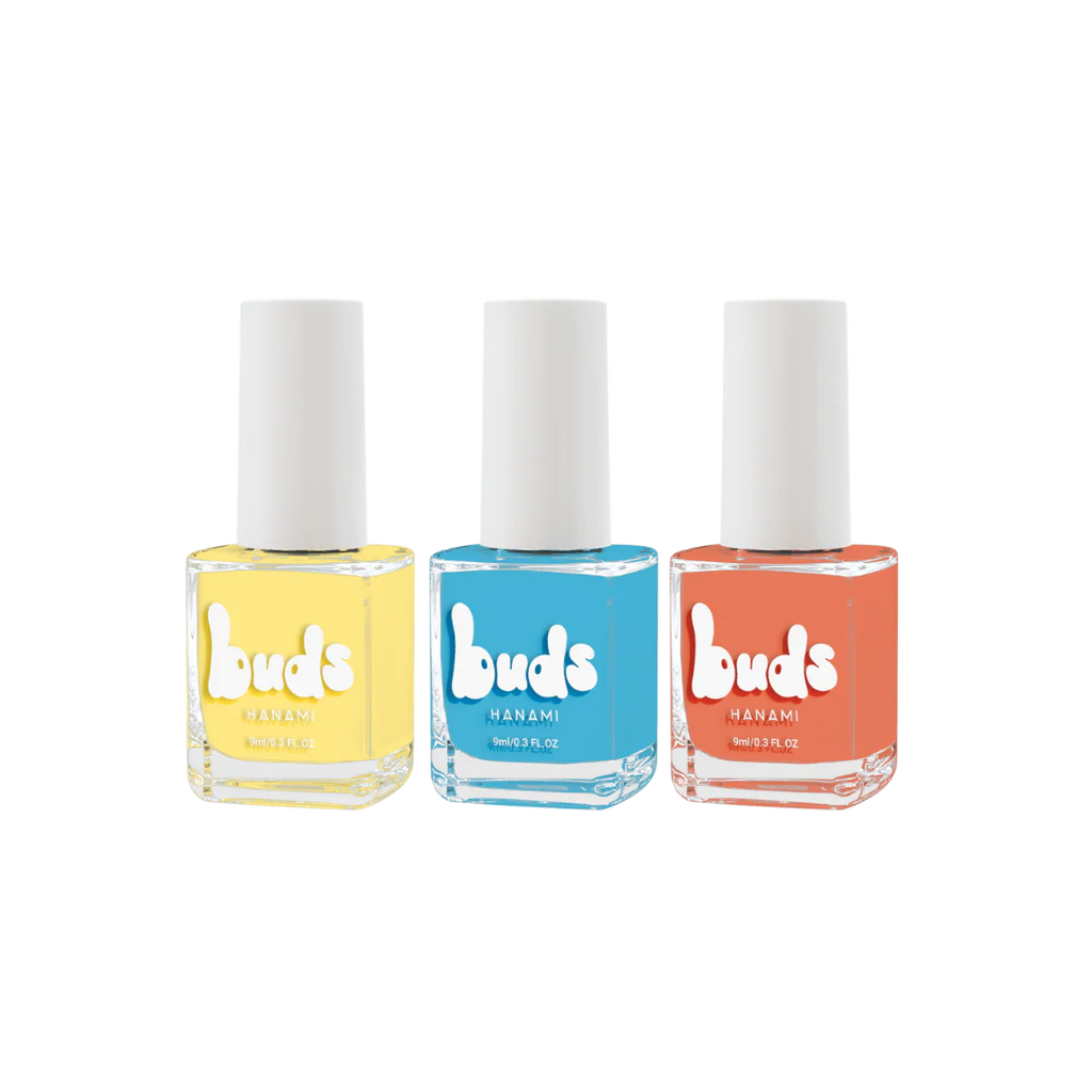 Three Buds Hanami kids’ nail polish bottles in a row: light yellow, bright blue, and coral orange, shown against a clean white background.