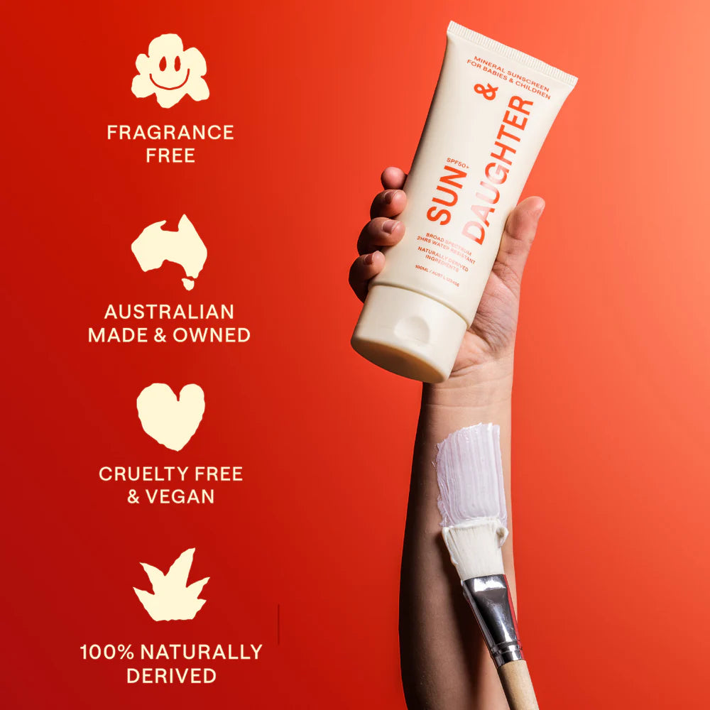 Hand holding Sun & Daughter sunscreen with icons highlighting cruelty-free, vegan, fragrance-free, and naturally derived benefits.