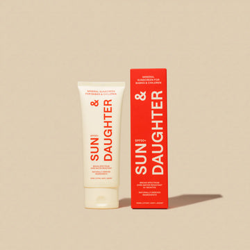 Tube and box of Sun & Daughter SPF50+ Mineral Sunscreen for babies and children, displayed on a beige background.