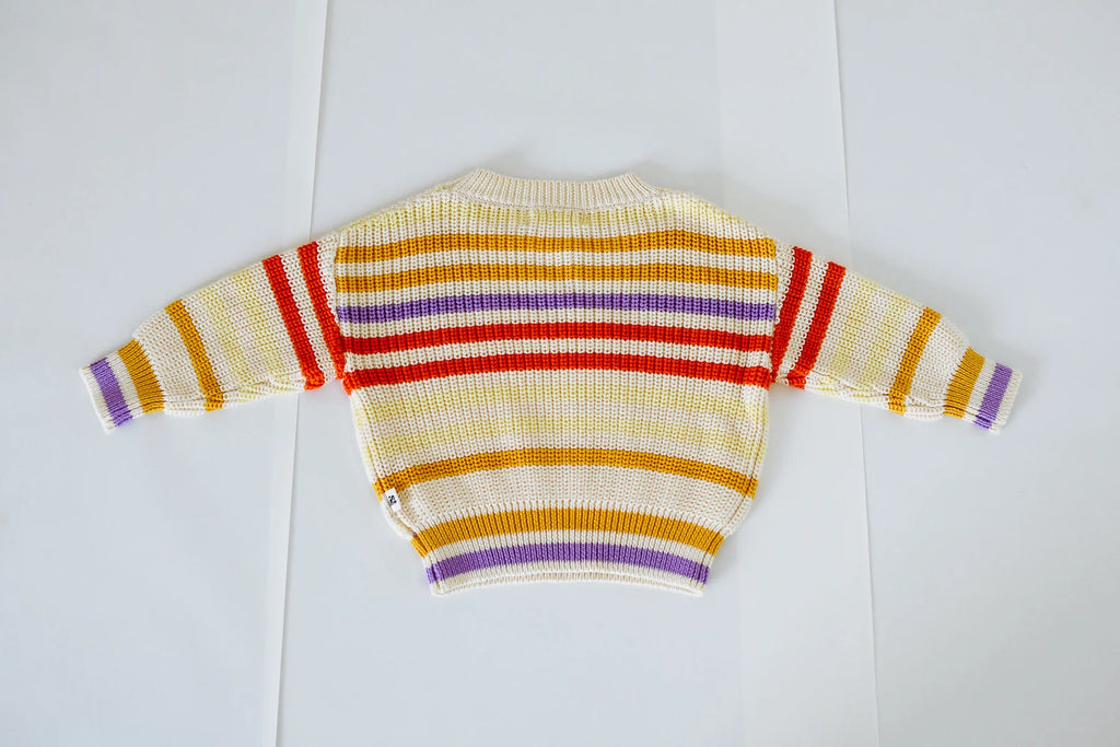 Flat lay of the Art Club Knit – back view – featuring a vintage-inspired striped pattern on a 100% cotton cream knit with a ribbed neckline and cuffs.