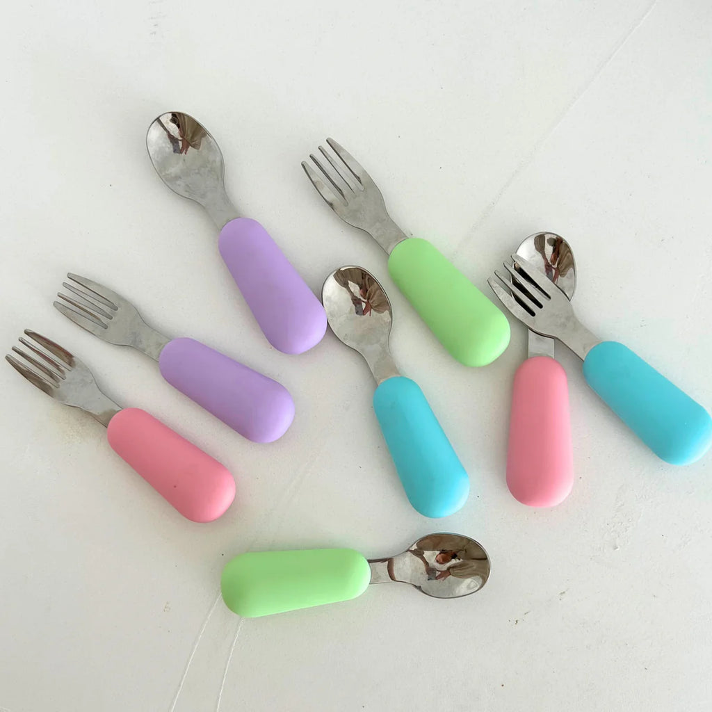 Top-down view of Zero Waste People spoon and fork sets in four colours – aqua, lime, lilac and watermelon – laid out on a white surface.