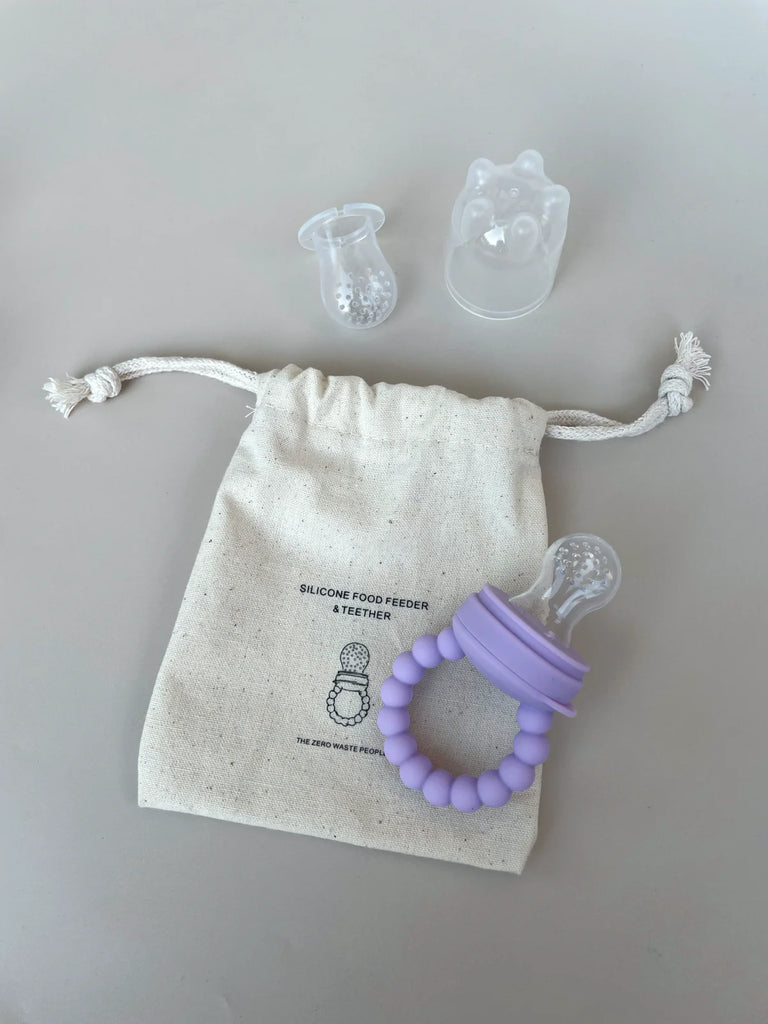 Lilac silicone baby feeder with teats and branded cotton pouch – eco-friendly, BPA-free feeder to support teething and independent feeding.