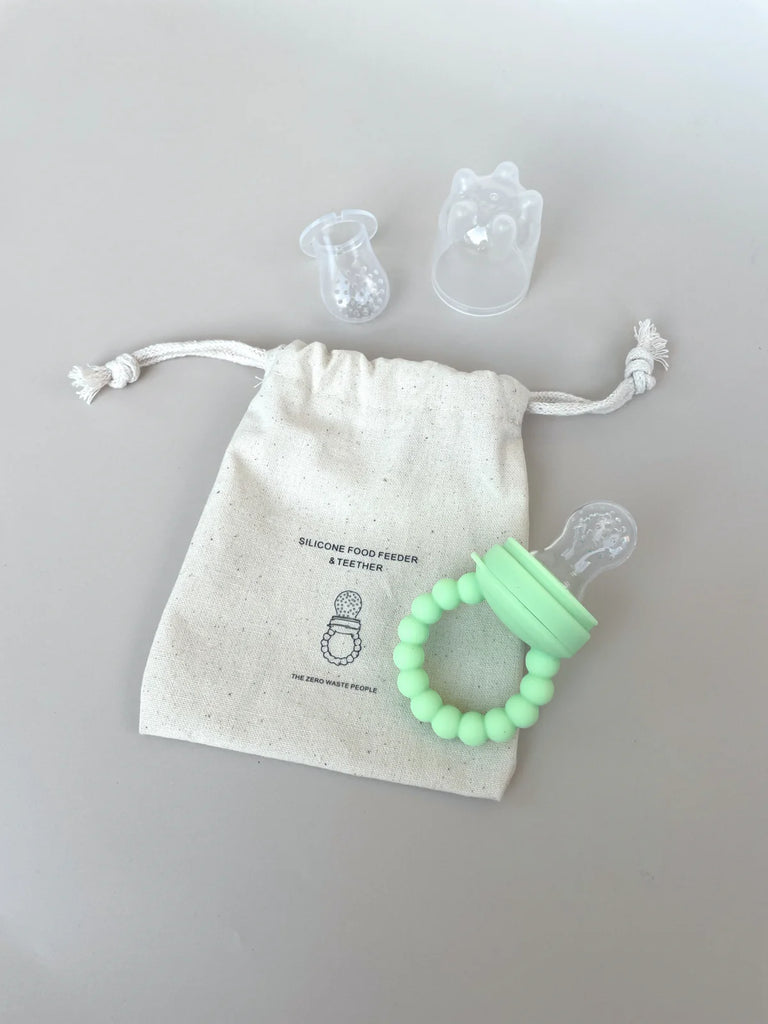 Green silicone baby feeder set with two teat sizes and storage pouch – ideal for teething relief and introducing solids, made from food-grade silicone.