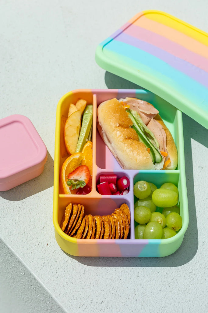 Rainbow  Bento Lunchbox with colourful lunch selection placed on a white surface – reusable and leak-proof food storage solution.