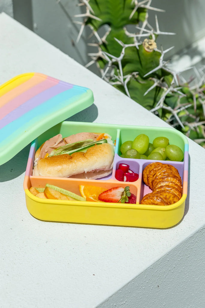 Open Bento Lunchbox in rainbow filled with sandwich, grapes, fruit, and crackers – eco-friendly lunch container for kids and adults.