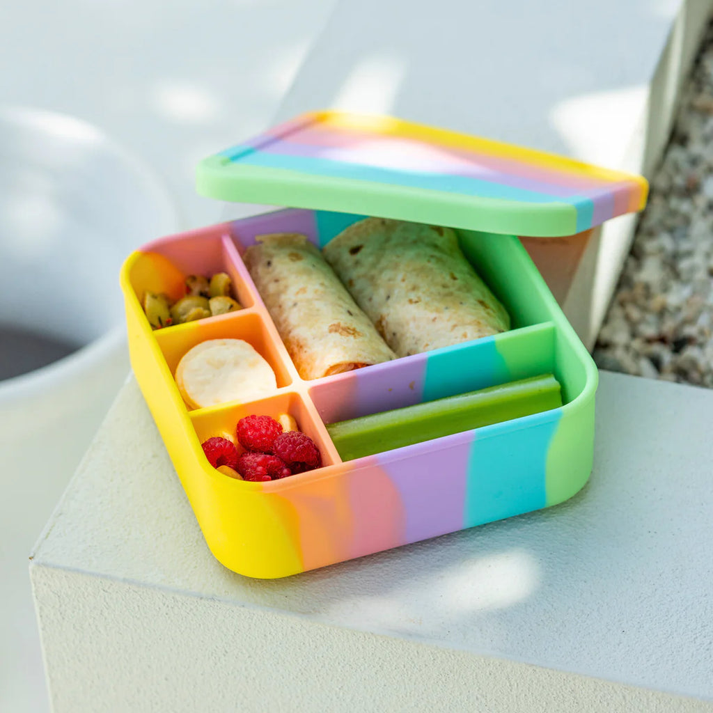 Open Big Bento Lunchbox in Rainbow colour filled with wraps, strawberries, banana, and veggie sticks – vibrant eco-friendly lunch solution.