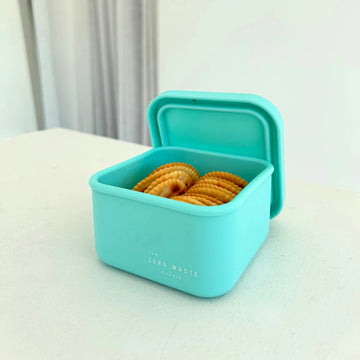 The Zero Waste People snack container in aqua, open and filled with crackers—perfect for leak-proof, on-the-go snacking for kids or adults.