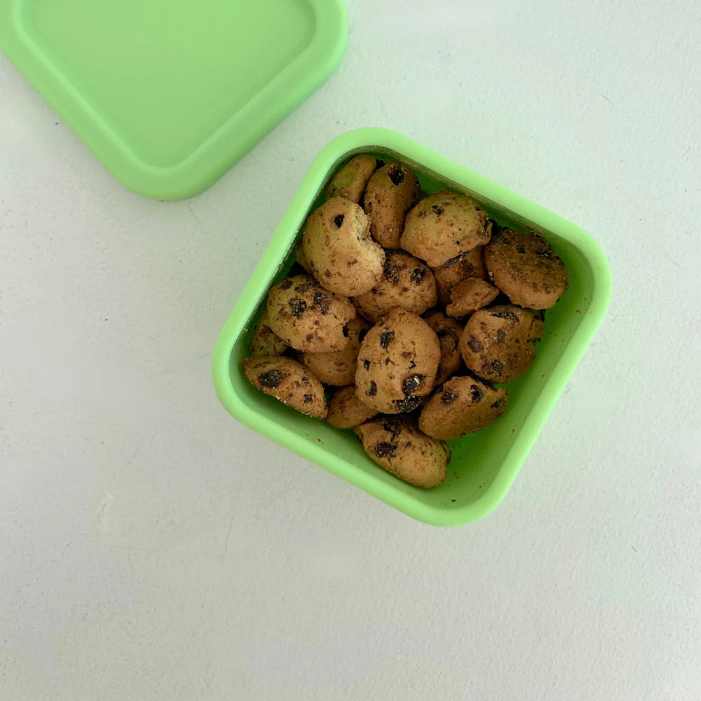 Top view of The Zero Waste People lime green snack container with biscuits inside—compact, colourful and lunchbox-ready.