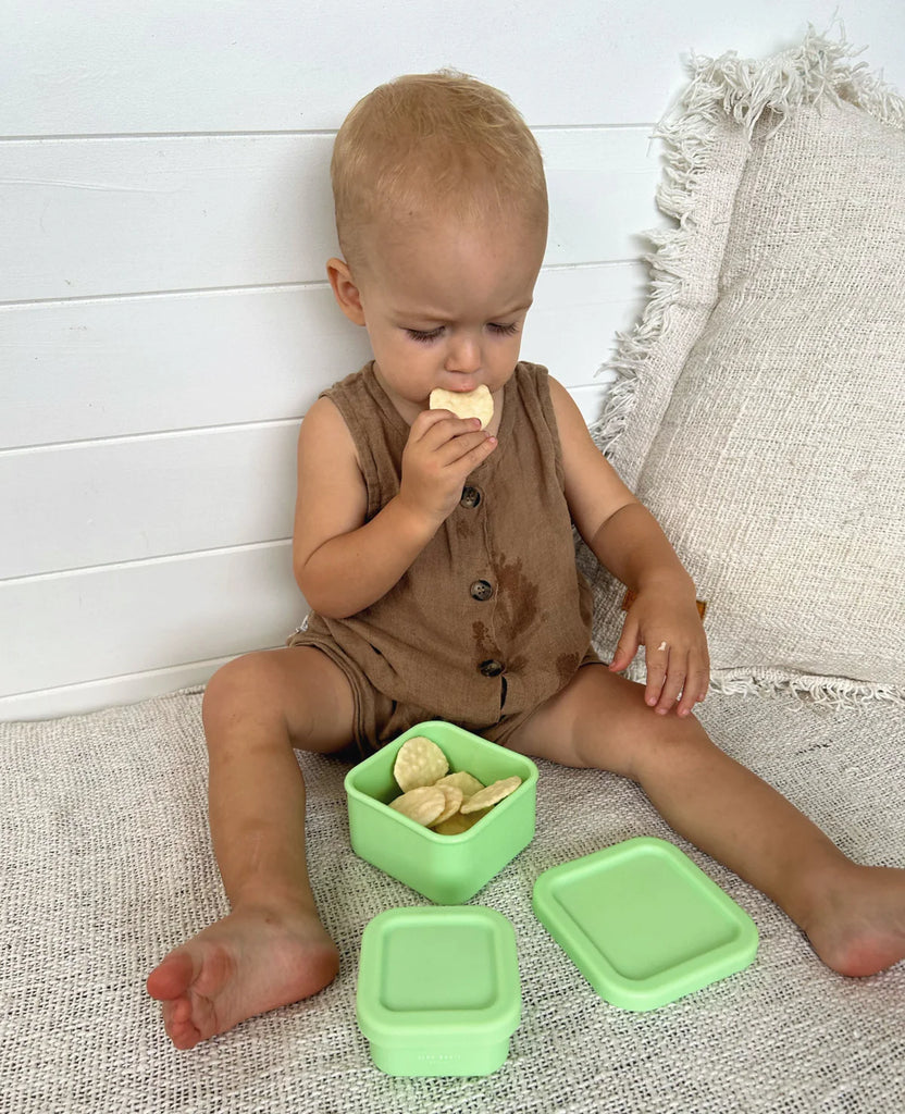 Toddler enjoying snacks from The Zero Waste People lime green snack containers—ideal reusable snack solution for busy little hands.