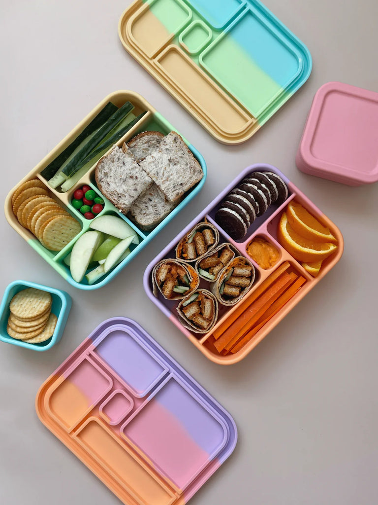 Open Bento Lunchbox with compartments of fruit, snacks, and sandwiches – microwave and dishwasher safe lunch solution.