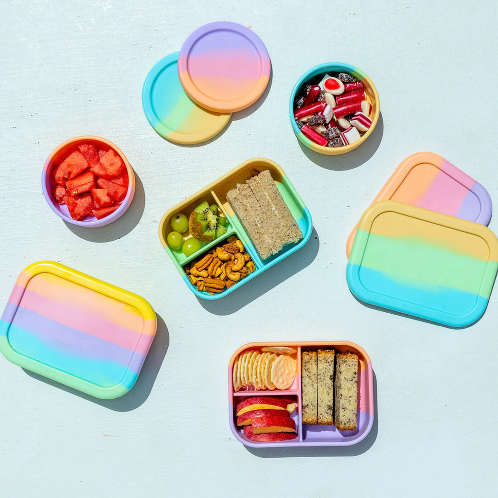 Flat lay of colourful Munchbox Minis in rainbow hues—eco lunchboxes designed for organised, waste-free snacking on the go.