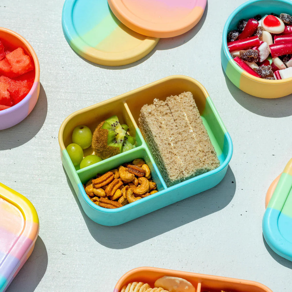 Open Munchbox Mini by The Zero Waste People filled with a sandwich, crackers, and fruit—durable eco lunchbox with 3 compartments.