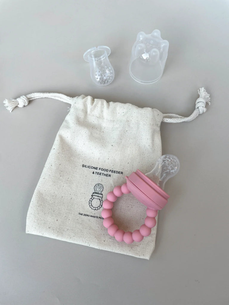 Pink silicone baby feeder with cover, two teat sizes, and storage bag – safe, non-toxic, and perfect for soothing sore gums or first foods.