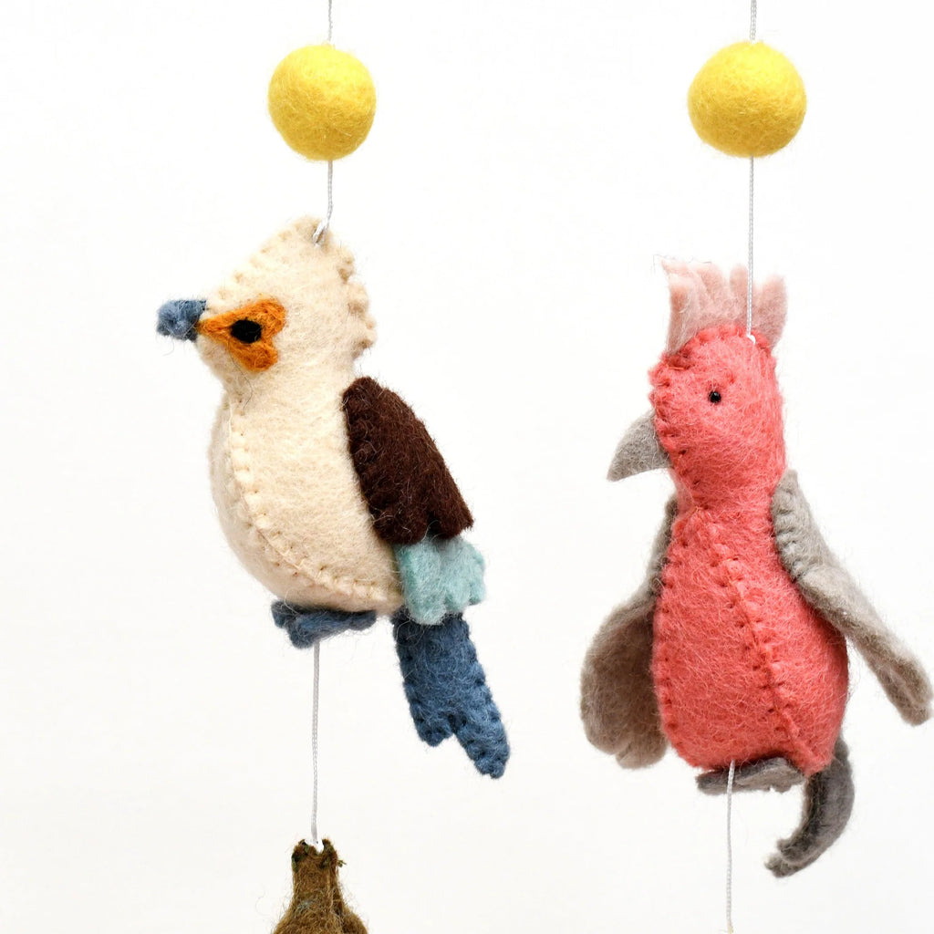Handmade Australiana-themed hanging featuring felt birds including a Cockatoo, Rainbow Lorikeet, Kookaburra, and Galah, surrounded by gum leaves, blossoms, and yellow wattle flower pompoms