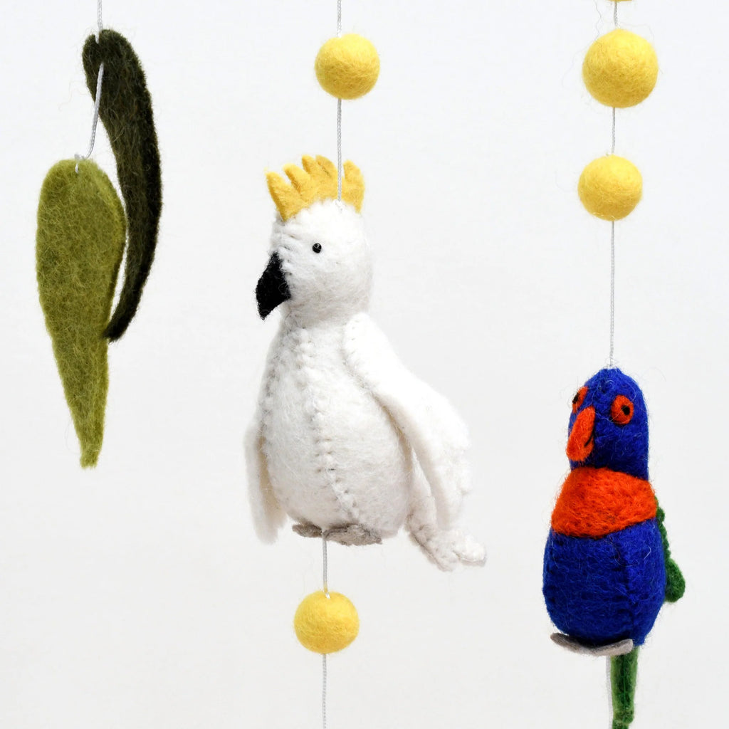 Handmade Australiana-themed hanging featuring felt birds including a Cockatoo, Rainbow Lorikeet, Kookaburra, and Galah, surrounded by gum leaves, blossoms, and yellow wattle flower pompoms