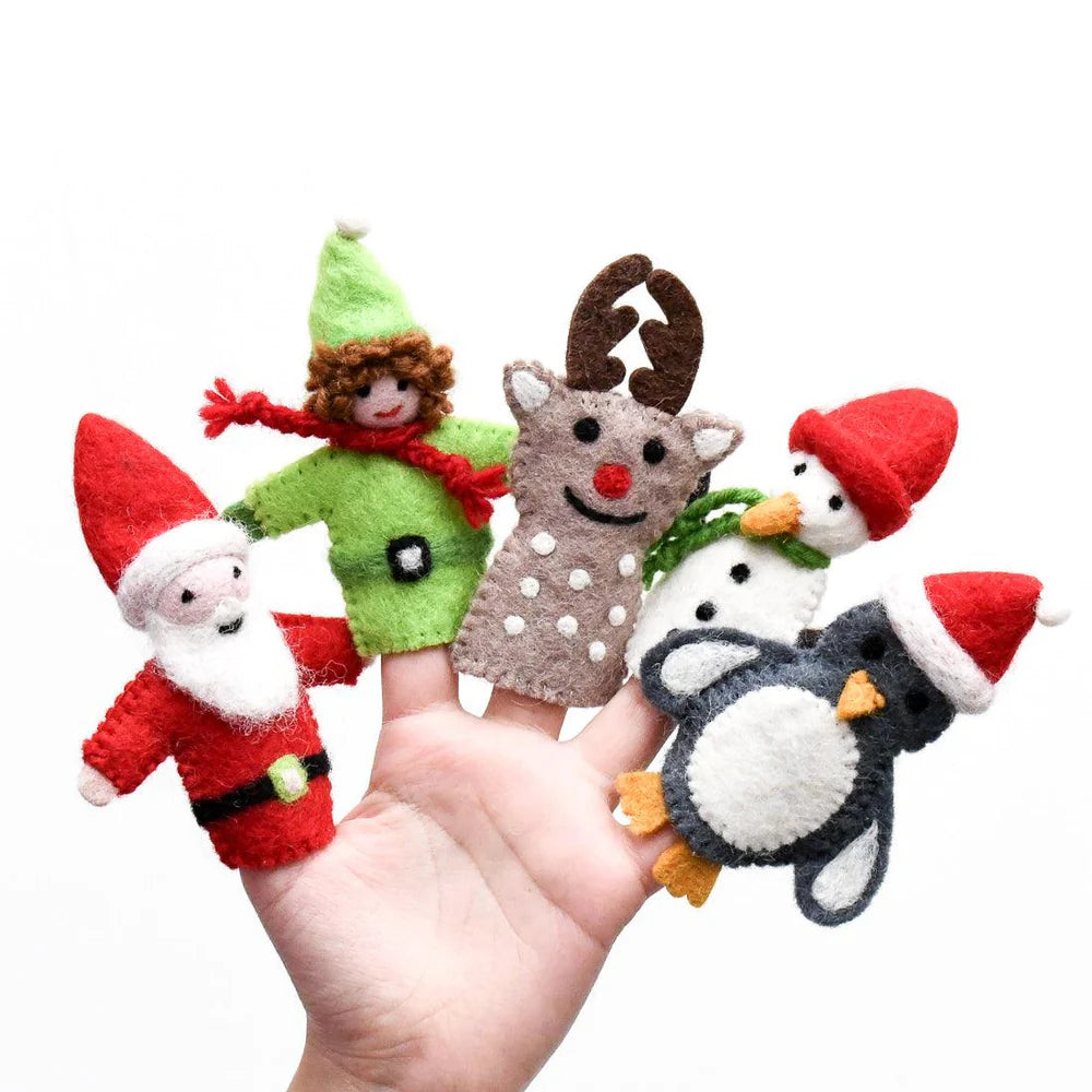 Set of Christmas-themed finger puppets on a hand against a white background