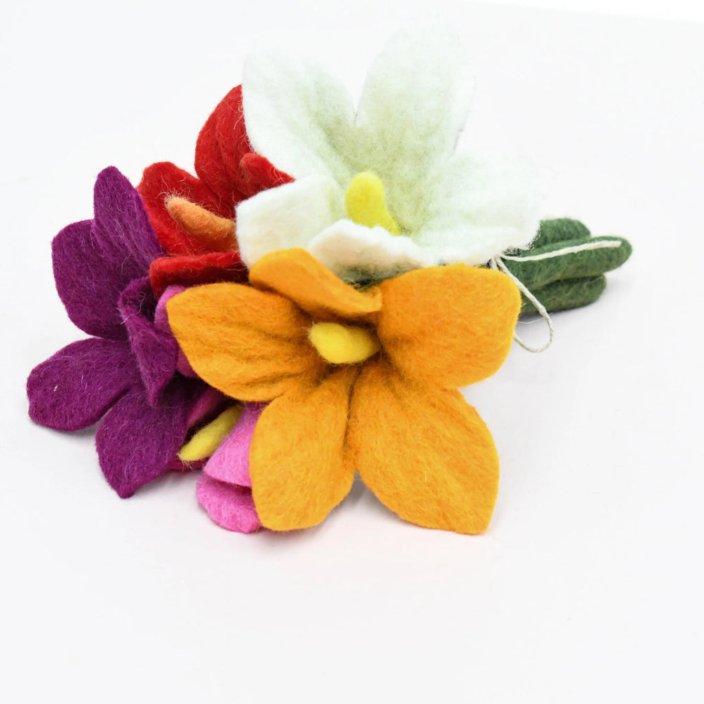 Mixed set of handcrafted felt flowers laid flat to showcase bright colours and child-friendly design.