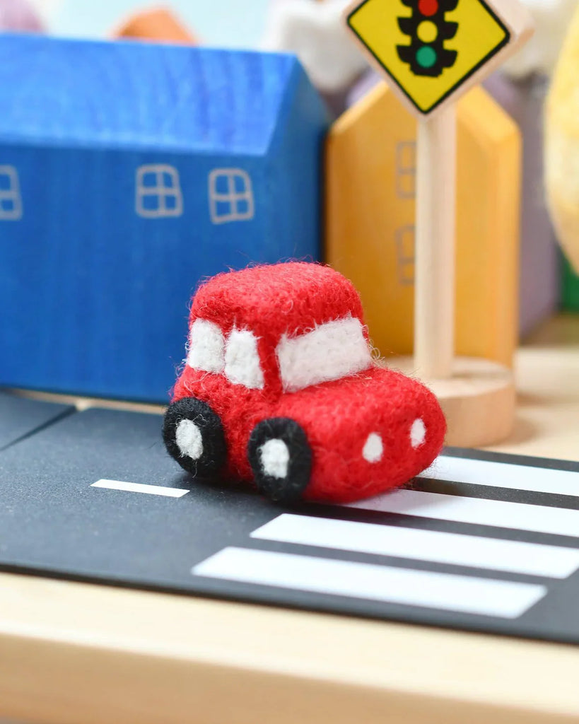 Handmade felt red car toy with soft detailing, ideal for imaginative play or nursery decoration