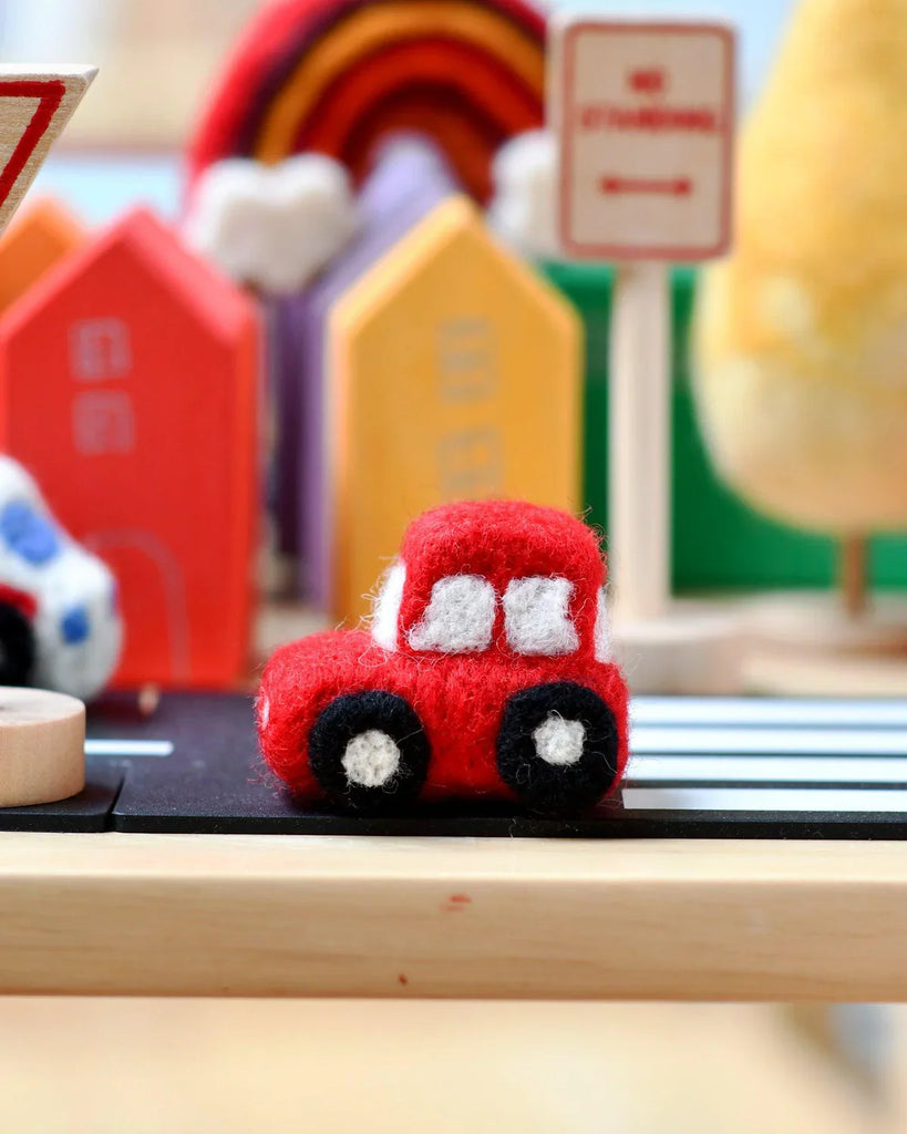 Handmade felt red car toy with soft detailing, ideal for imaginative play or nursery decoration
