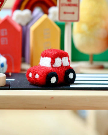 Handmade felt red car toy with soft detailing, ideal for imaginative play or nursery decoration