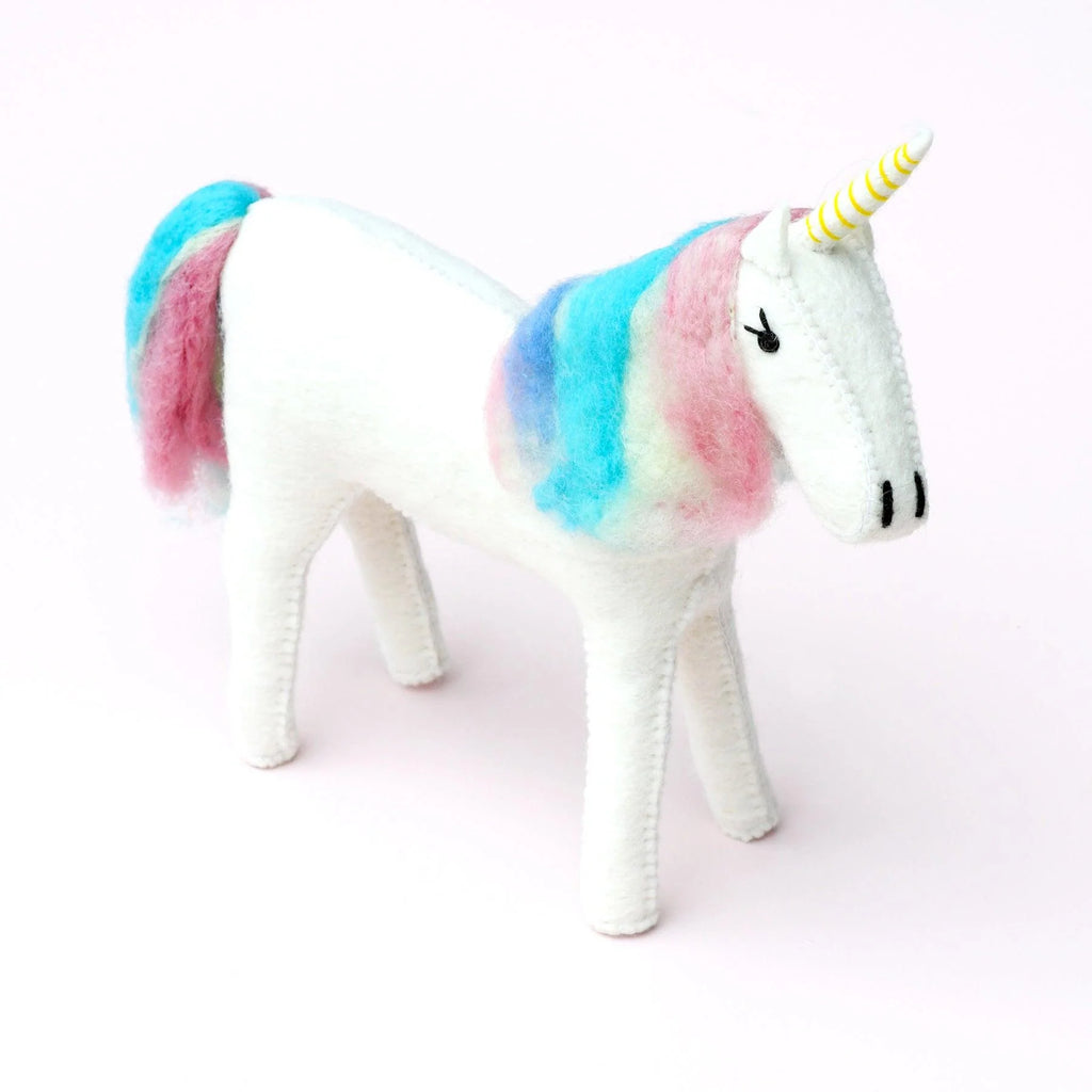 Side view of large handcrafted unicorn with rainbow-coloured mane and tail, made from wool felt.