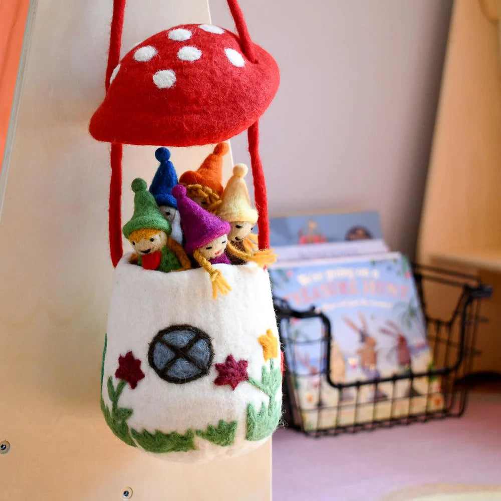 Felt toadstool bag displayed on a child’s bedroom shelf, showing size and charming hand-stitched details.