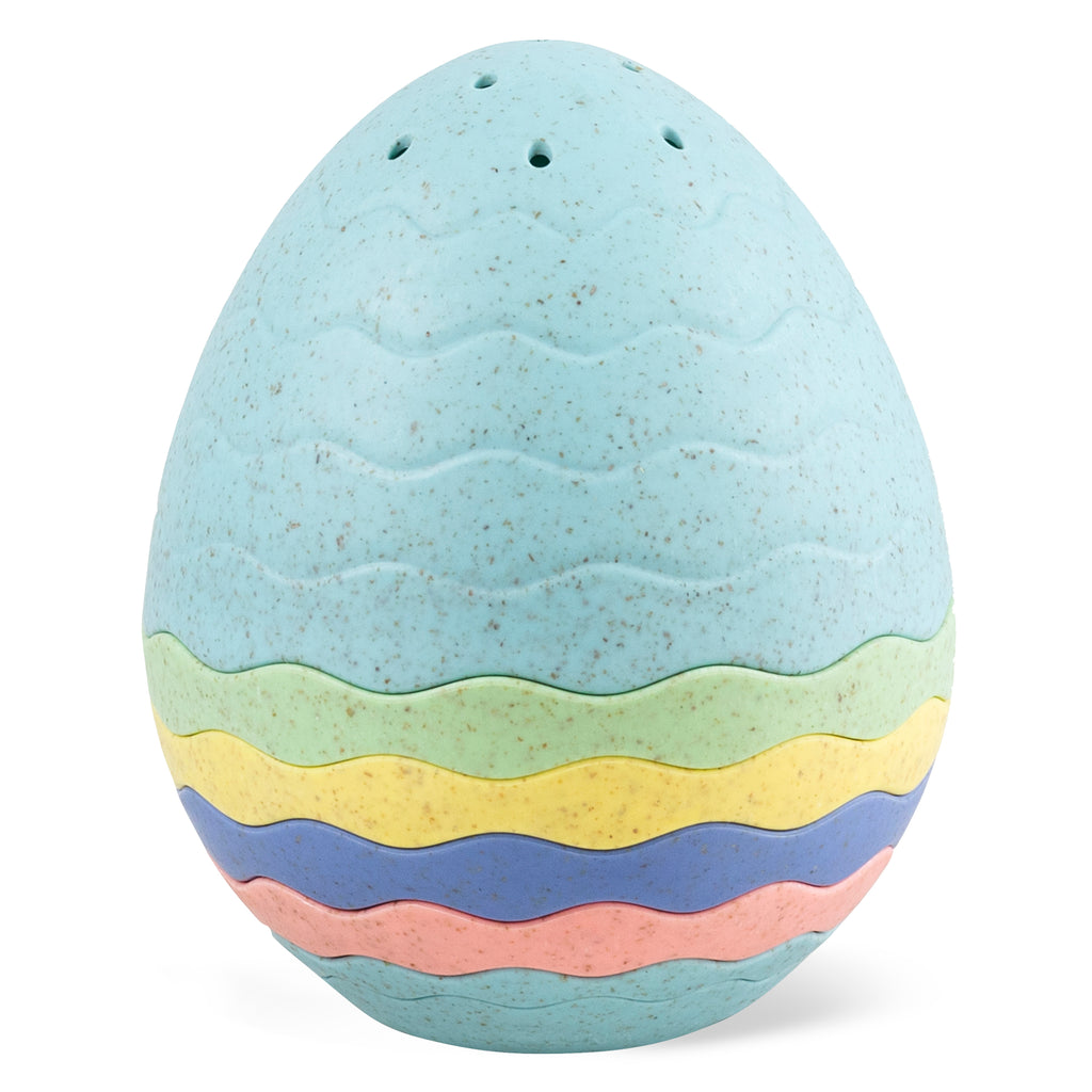 Close-up of the Bath Egg stacked into a closed egg shape with pastel blue, green, yellow, pink, and orange layers visible.