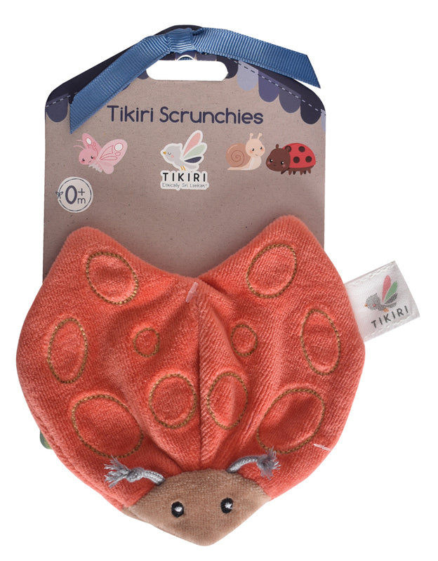 Ladybug Scrunchie Toy displayed in eco-friendly cardboard packaging, showcasing OE100 certification and suitability for newborns and up.